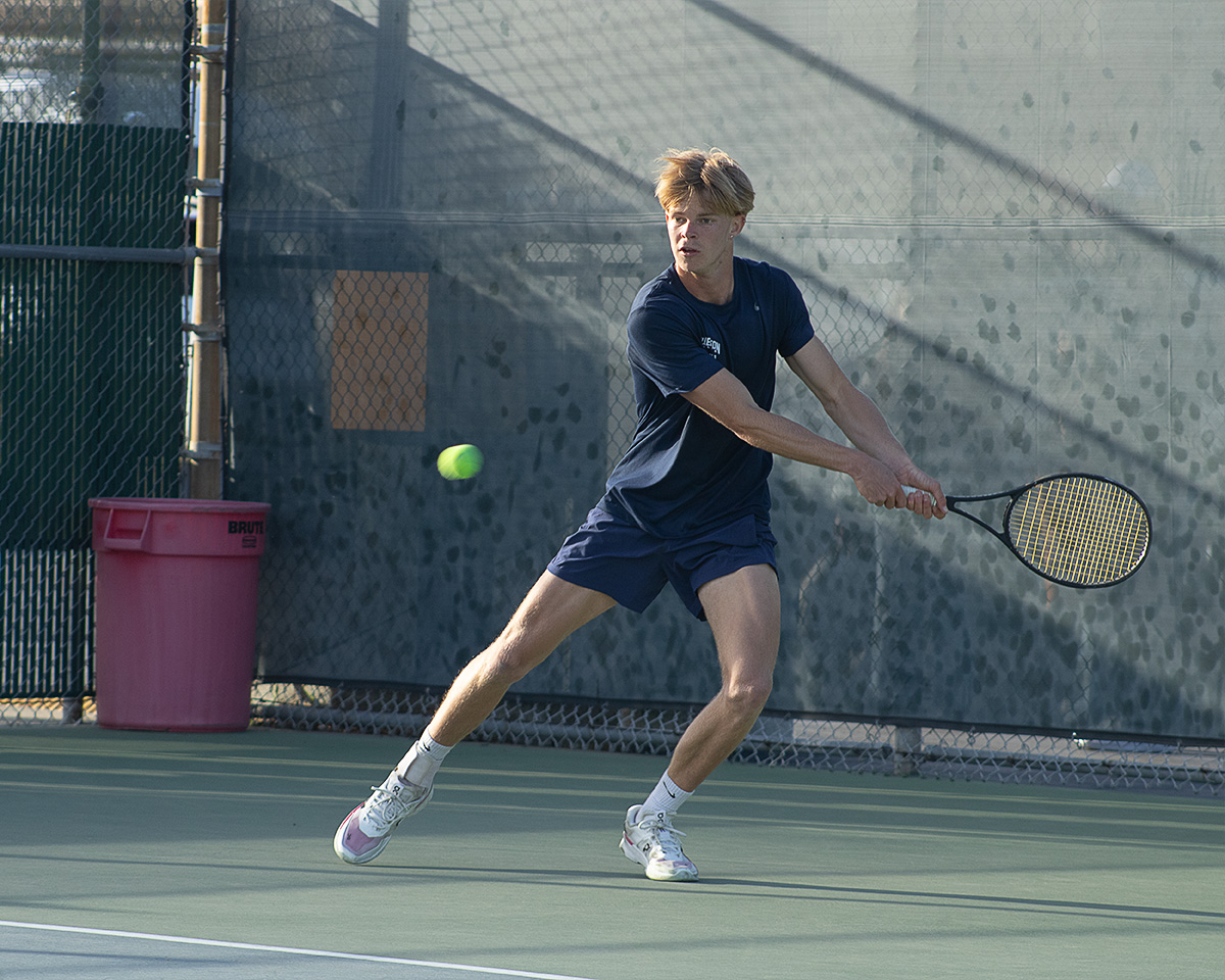 Sebastian Koster runs to strike the ball in a singles match with Gustavus Adolphus College at Fullerton College on Mar. 4, 2025.