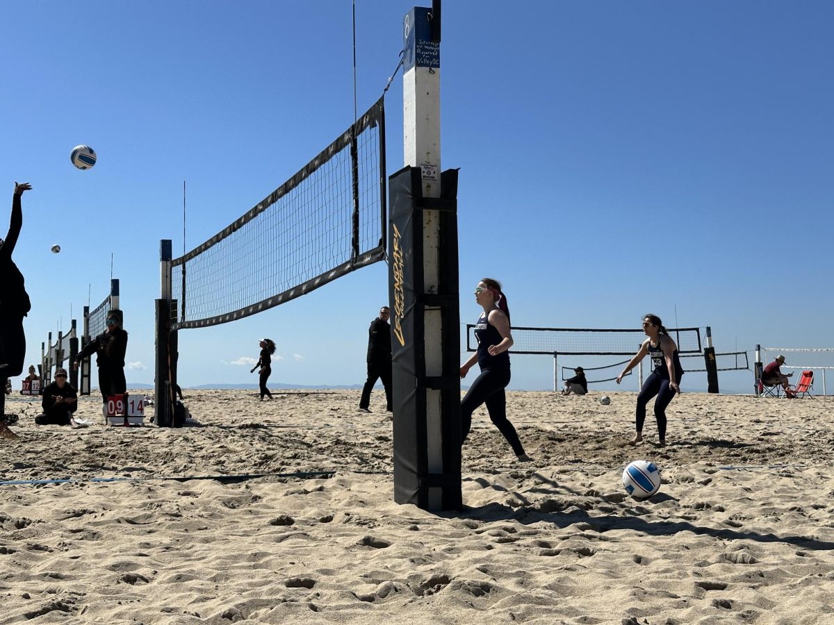 Bri Stotemore and Izzy Hernandez get set to receive the serve against Riverside on March 7, 2025