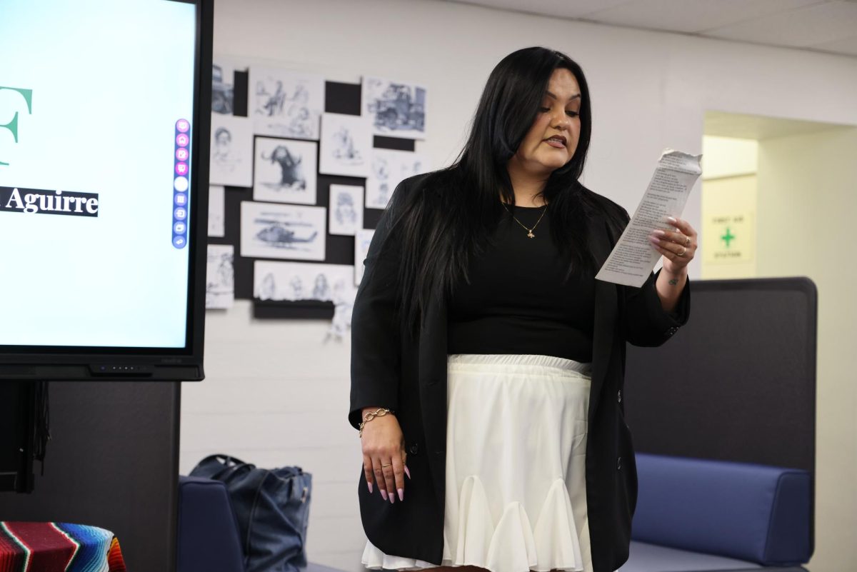 Angela Aguirre recites her poem “What Were You Born Into” on Tuesday, March 4, in the Administration building during her Women’s "Herstory" Month workshop.