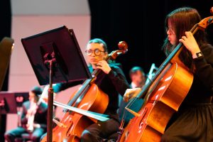 Tabitha Martinez (left) and Rachel Seo rehearse with their violoncellos before their performance in the Fullerton College Symphony at the Campus Theatre on Wednesday, April 23.