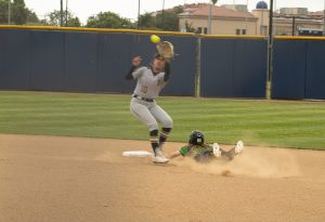 Golden West College's Reggi Frei slides toward second base as Fullerton College's Linsey Arostigue catches the ball.