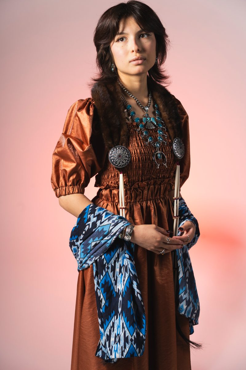 The author stands confidently in her Native adornments and attire—something she was once embarrassed of. 

 