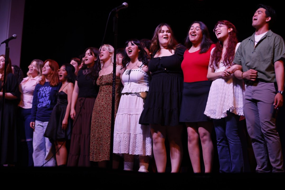 The musical theater ensemble class embraces for the final song of the recital held at the Wilshire Auditorium on May 20, 2025.