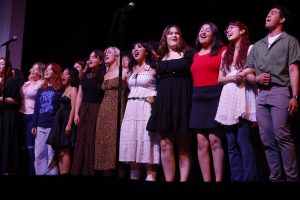 The musical theater ensemble class embraces for the final song of the recital held at the Wilshire Auditorium on May 20, 2025.