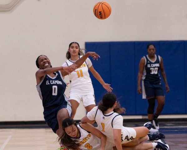 Jackie King of El Camino gets swarmed by Fullerton players Femi Nodal and Chloe Chang in a home basketball game in Fullerton, Calif. on November 5, 2025.