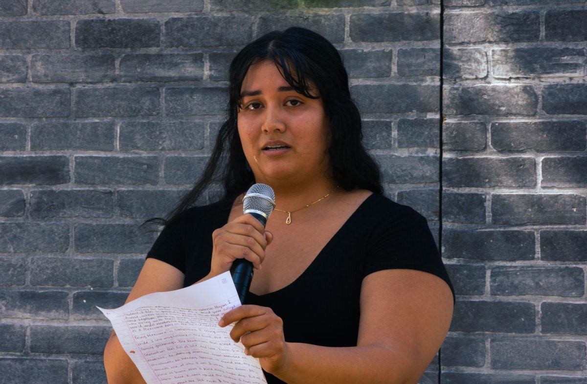 Valeria "Val" Huijon shares a poem, which she wrote when she was overwhelmed with emotions after attending an anti-ICE protest earlier this year, at Fullerton College's first Latinx Heritage Month Open Mic hosted by Scholars Unidos on Sept. 17, 2025.