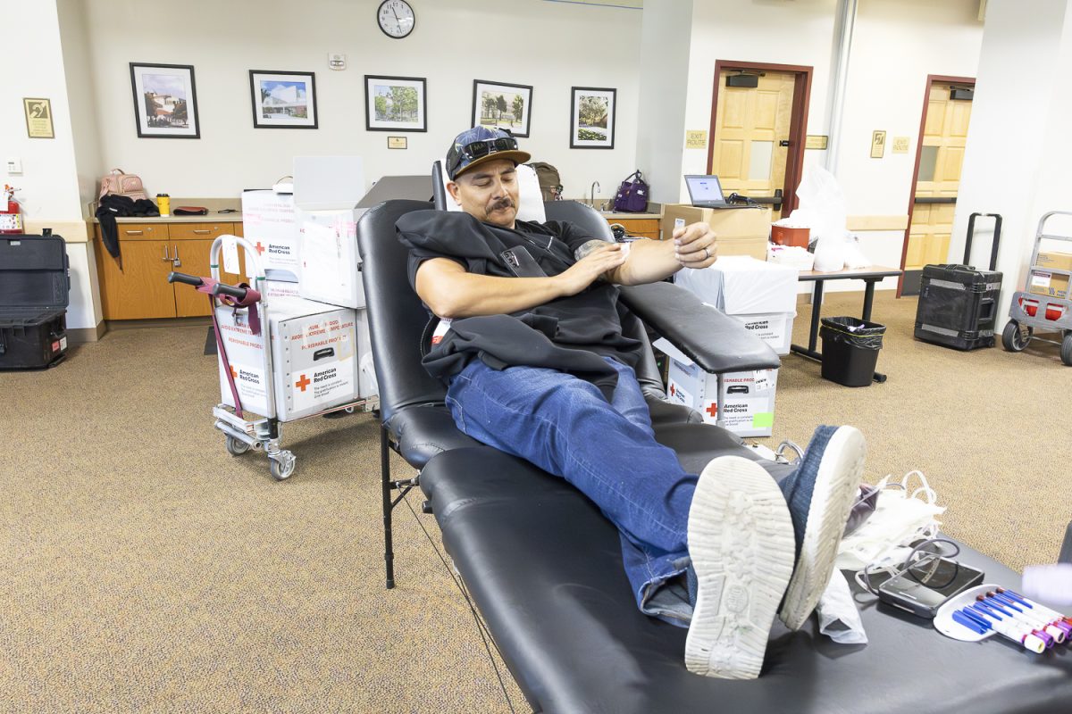 A second donor begins the blood donation process at one of the prepared stations during the Red Cross blood drive at Fullerton College. (Myron Perez)
