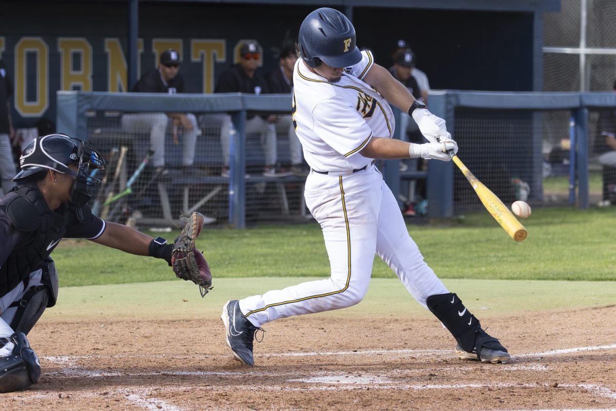 Fullerton College hitter, Kai Hopfel, gets a hit against Long Beach City College.