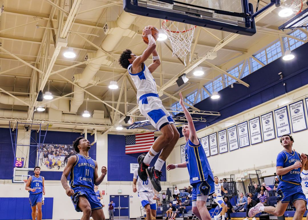 Yoda Oke goes up for an alley-oop dunk from a Kairi Shepherd pass on Feb. 12, 2026 in Fullerton, Calif.