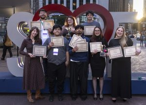 The Hornet and Inside Fullerton editorial staff and Adviser Jessica Langlois pose in front of a Love SF sign with some of the awards that were given to the publications at the Associated Collegiate Press National College Media Conference in San Francisco on March 7, 2026.