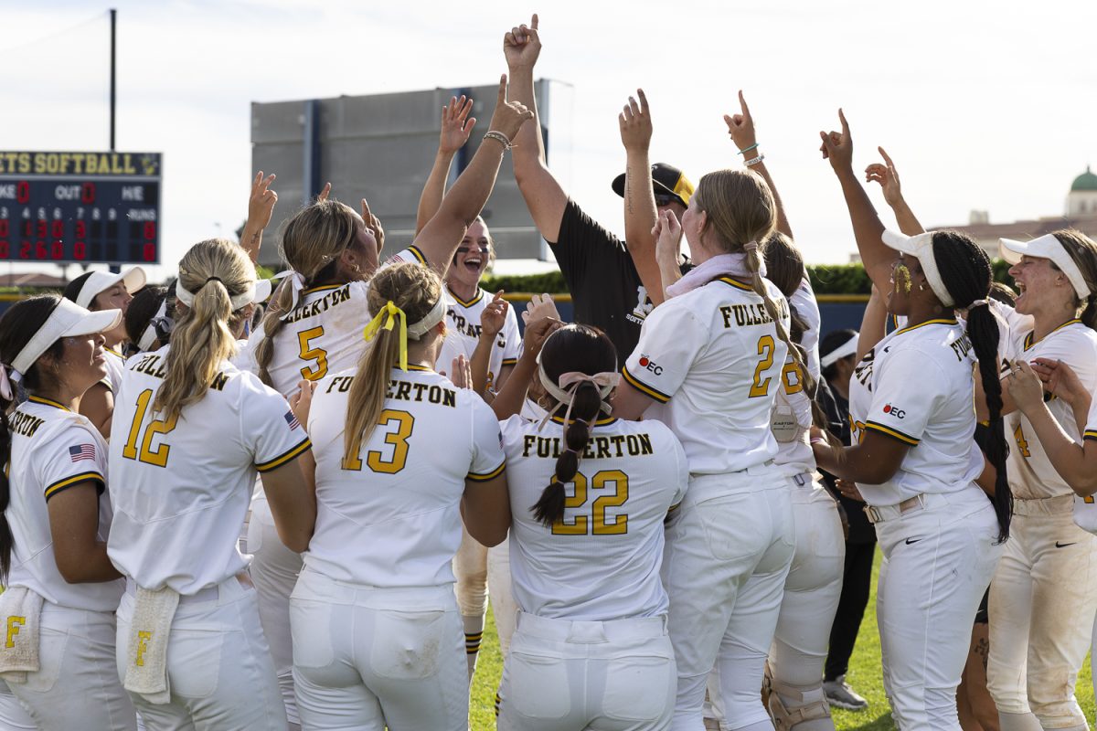 Fullerton College players leap with their fingers raised in celebration following a walk-off home run to defeat Cypress College on March 13, 2026, at the Fullerton College Softball Field in Fullerton, Calif.