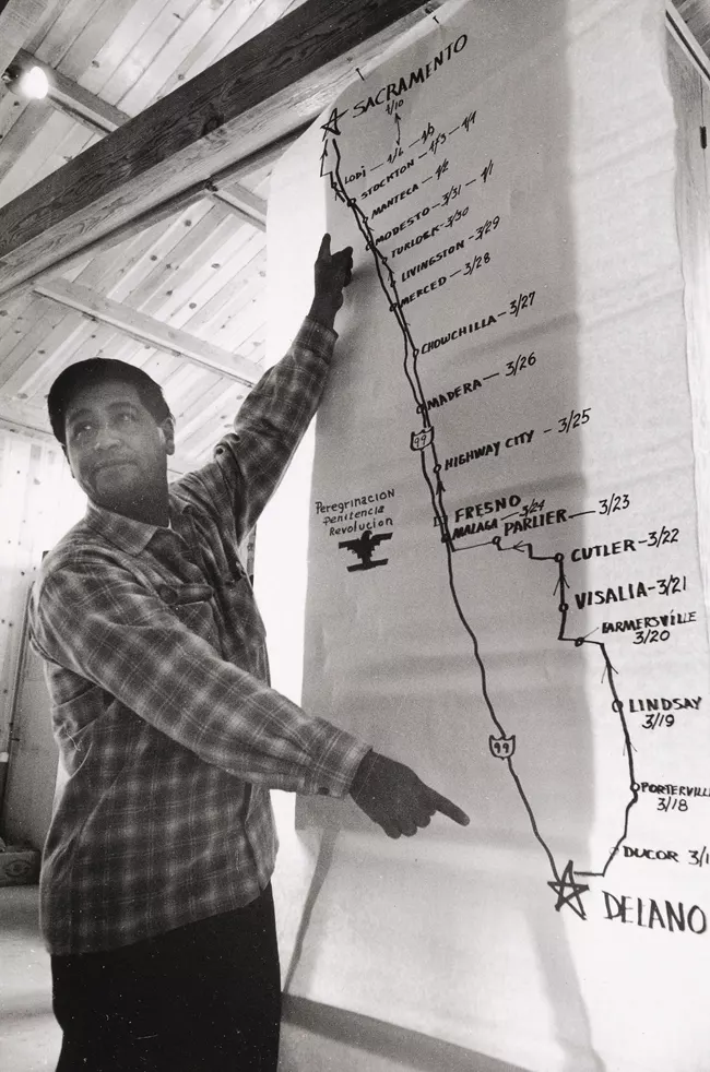 Cesar Chavez, co-founder of the National Farm Worker Association, stands in front of map of the 1966 march route.