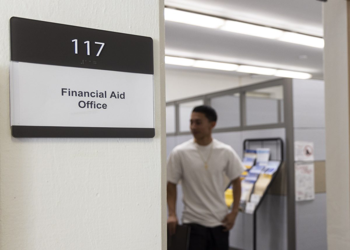 Fullerton College student Allen Hernandez receives assistance from the Financial Aid Office.
