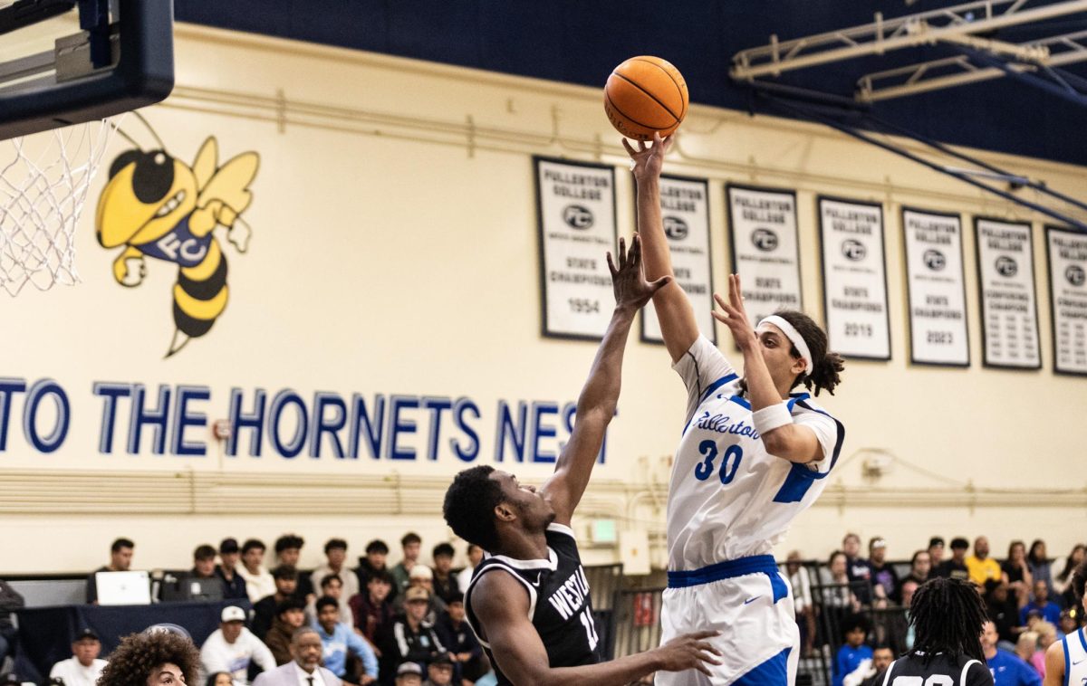Fullerton's Brayden Smith attempts a hook shot over West L.A.'s Jemeil Rich on March 7, 2026, in Fullerton, Calif.