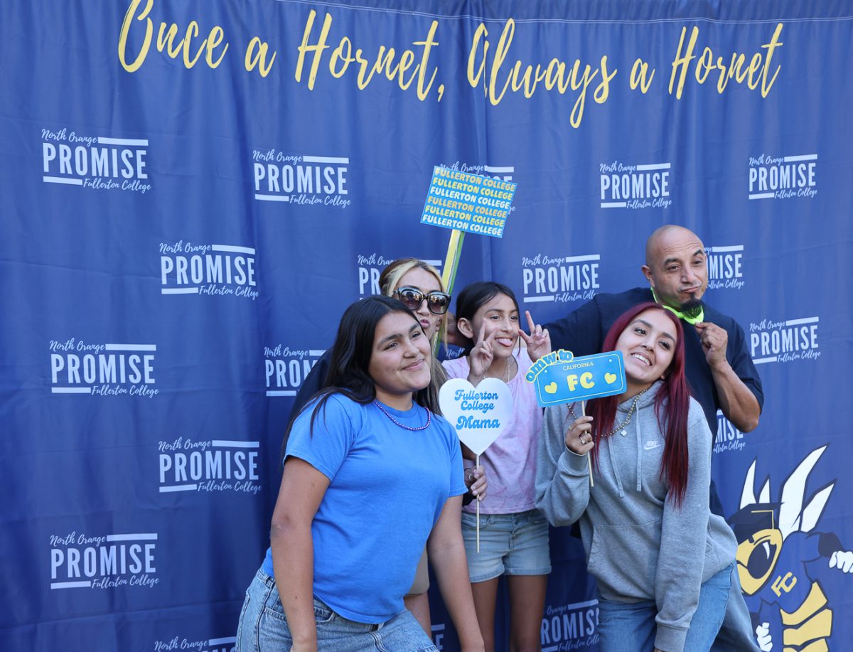 Future Hornets and their family pose at the Photography Department's photo booth at Fullerton College on FC Night, April 15, 2026.