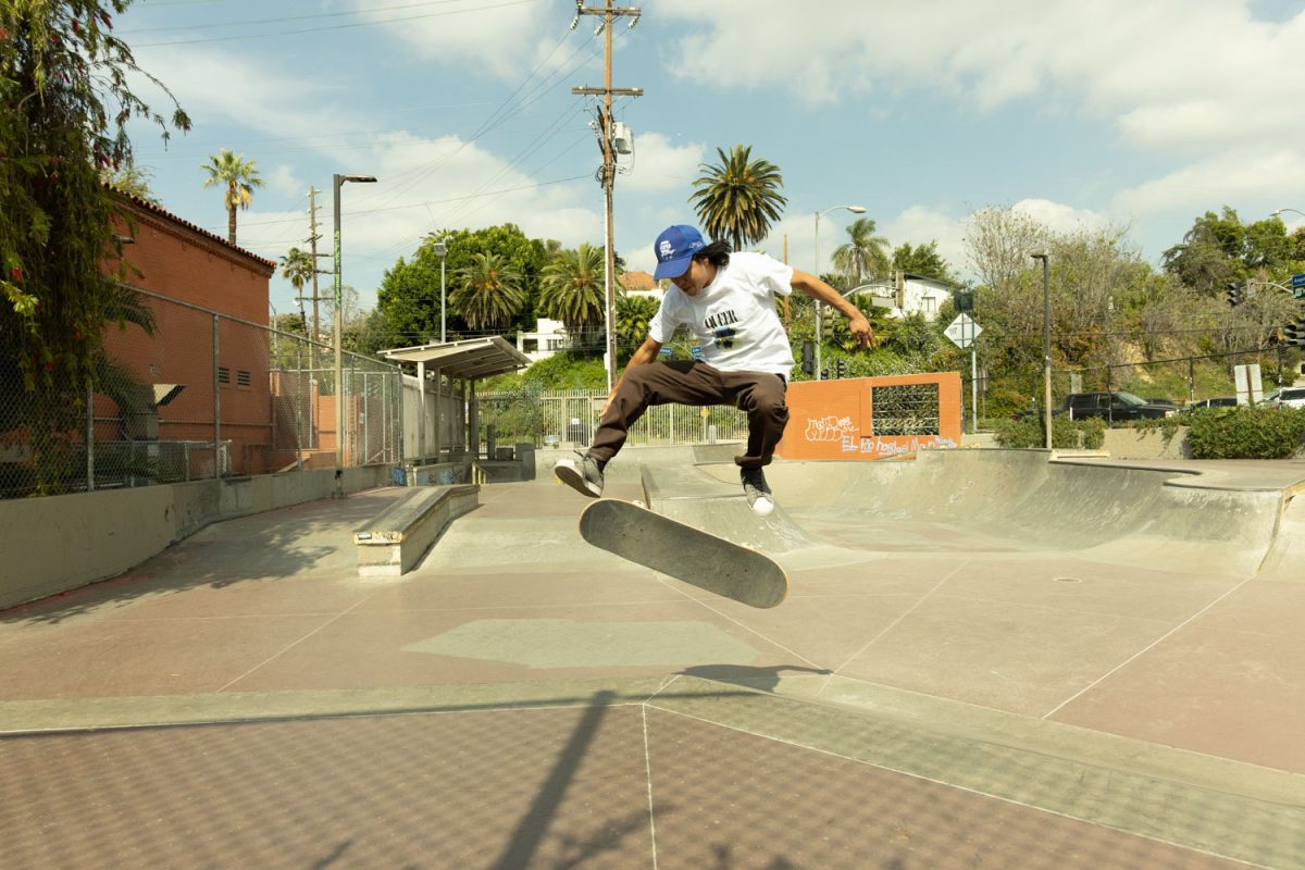 Echo Park skater doing a flip trick off a ramp.