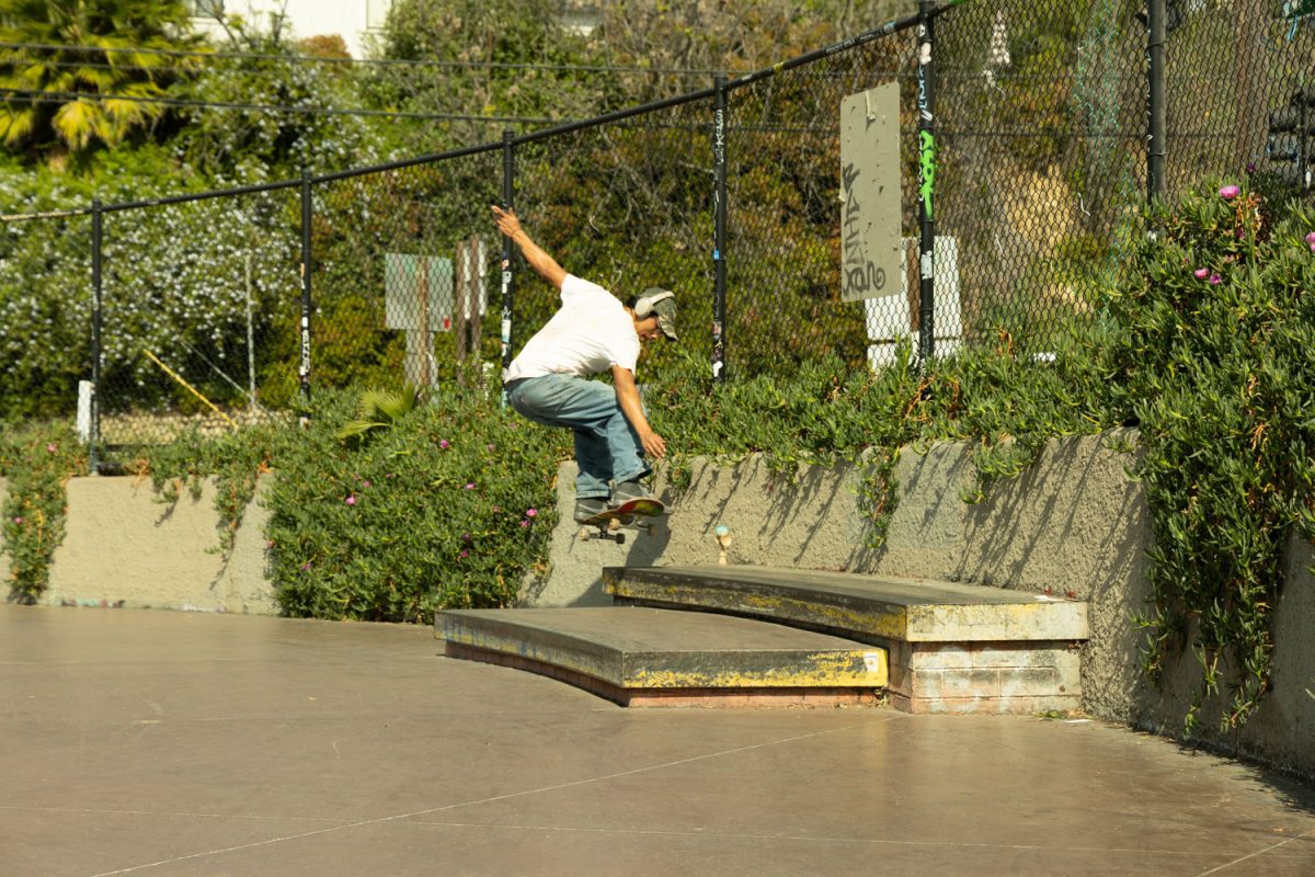 Alex Salome grinding his board on a curb at Echo Park.