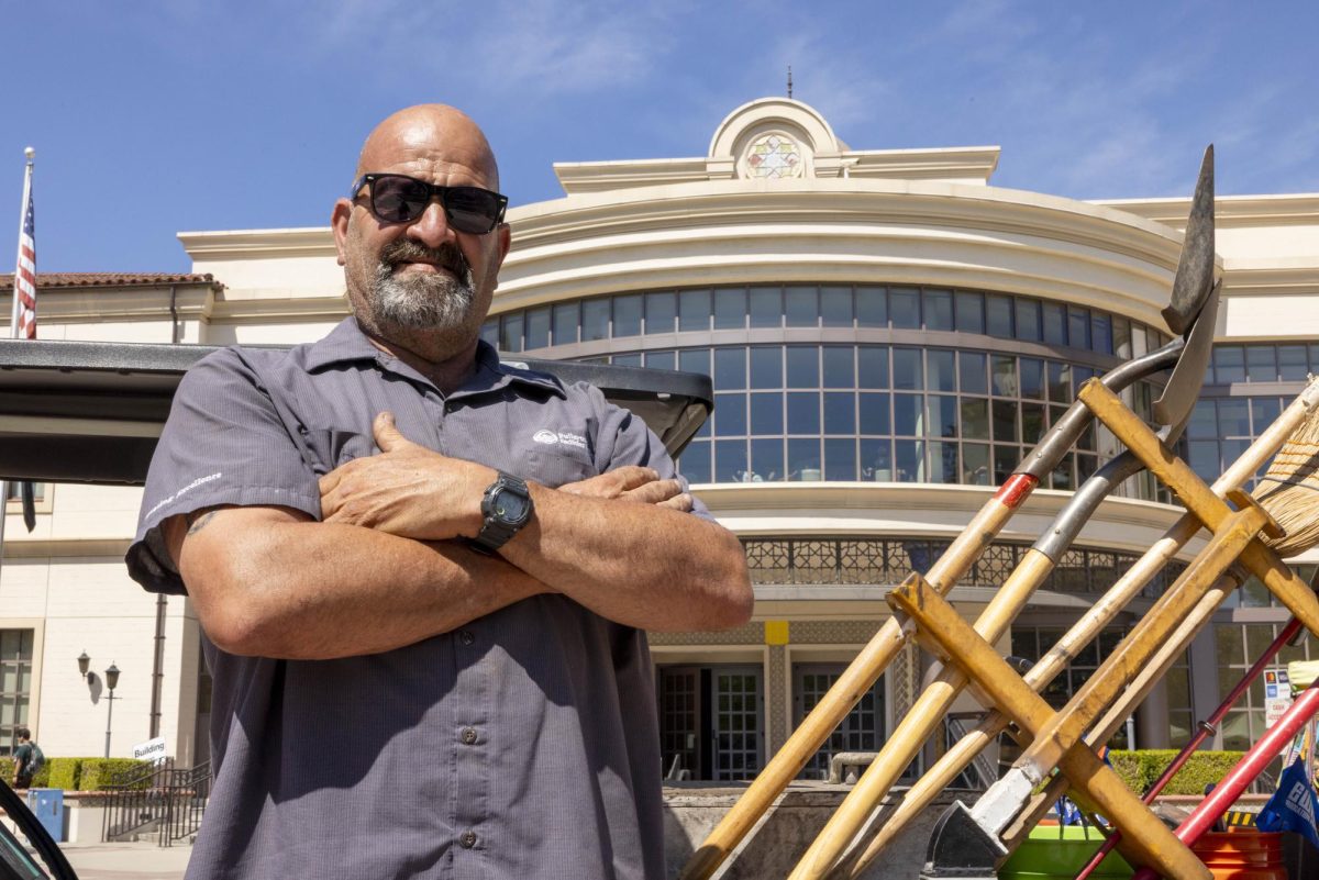Gary Alamo, the irrigation specialist for Fullerton College, poses in front of the William T. Boyce Library.