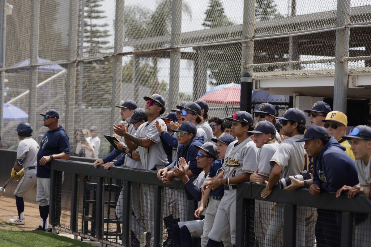 The Hornet dugout cheers on their teammates in the first inning against Santa Ana College on May 15 at Don Sneddon Field in Santa Ana, Calif.